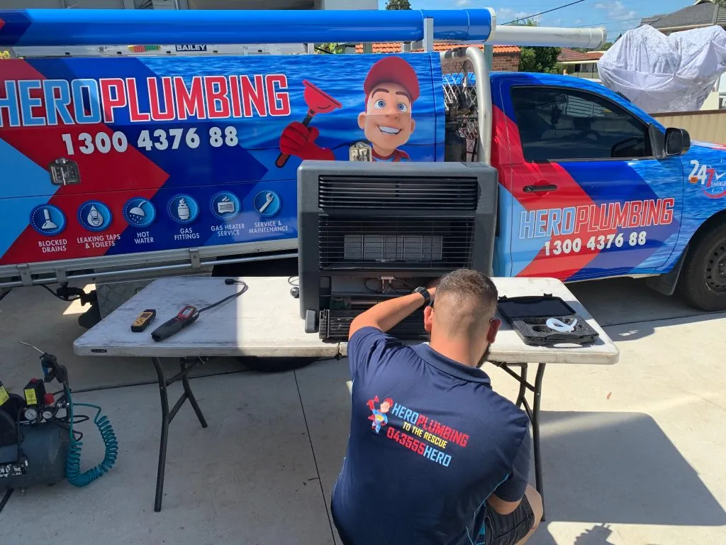 Hero Plumbing Gas Heater Service Technician Fixing a Heater